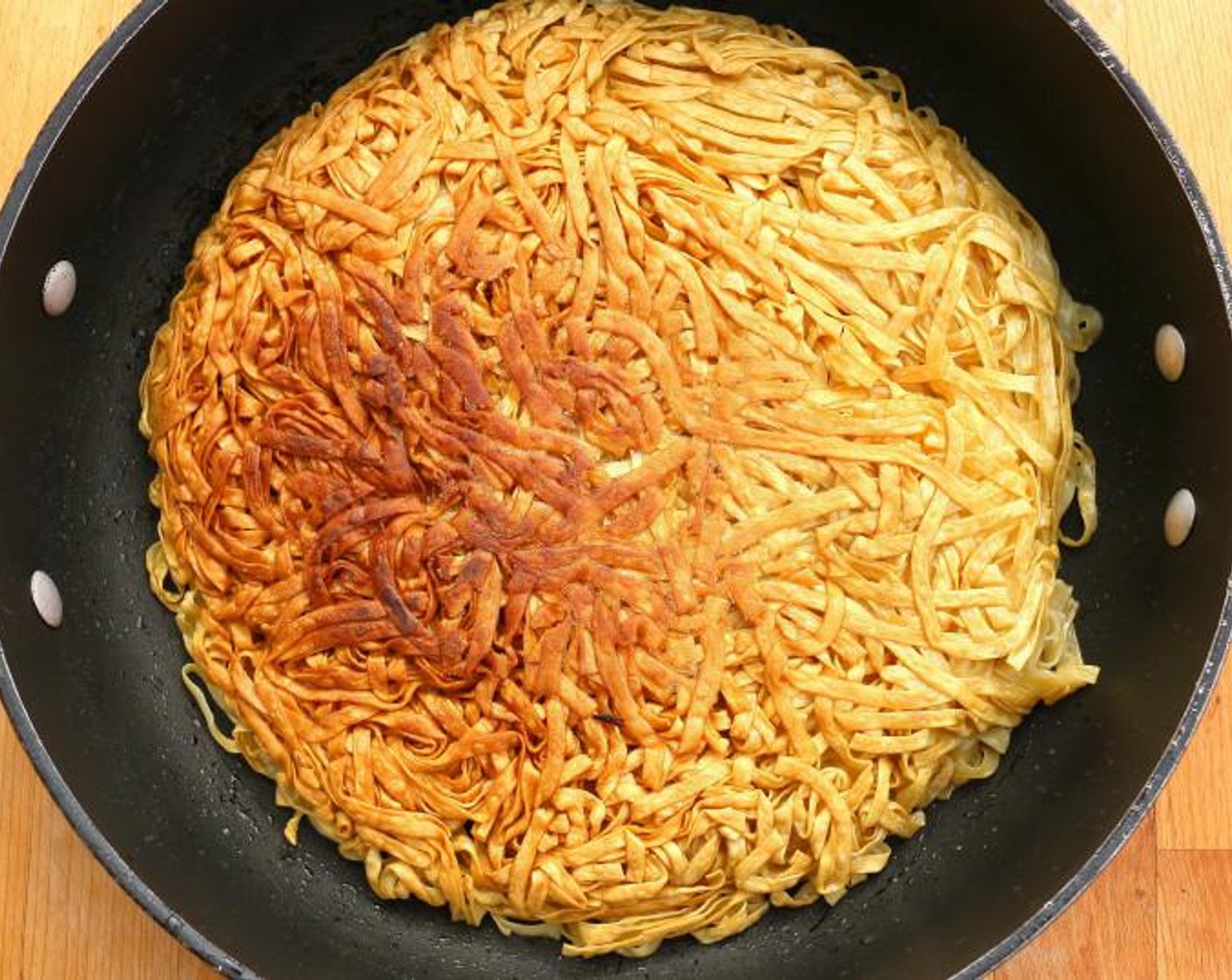 step 2 When the noodles are crisp, flip and cook on second side to a crisp and golden brown.