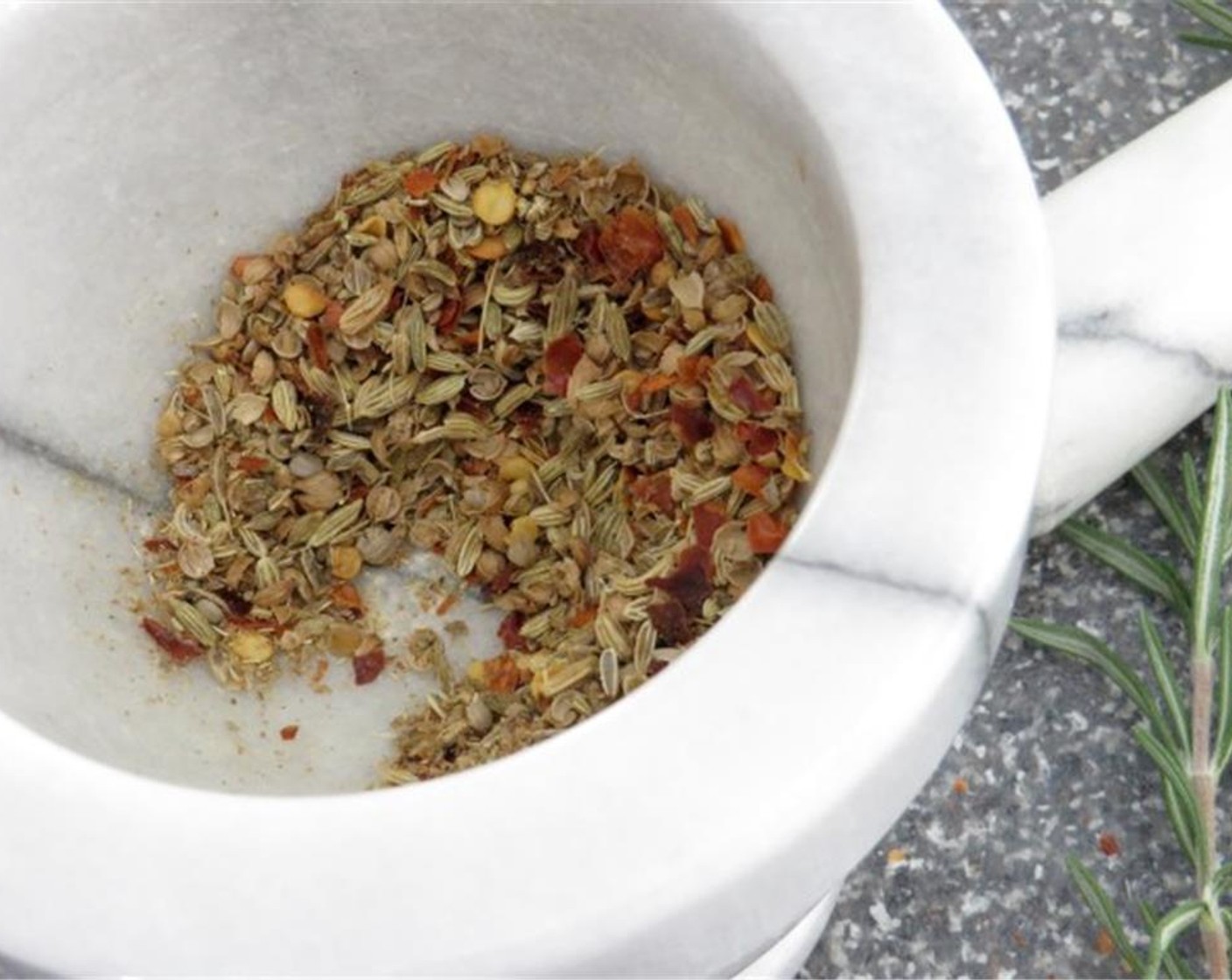 step 1 In a mortar and pestle, combine Whole Whole Coriander Seeds (1/2 tsp), Fennel Seeds (1 tsp), and Crushed Red Pepper Flakes (1/2 tsp). Use the pestle to crack and grind the spices in the mortar until the spices are crushed and fragrant.