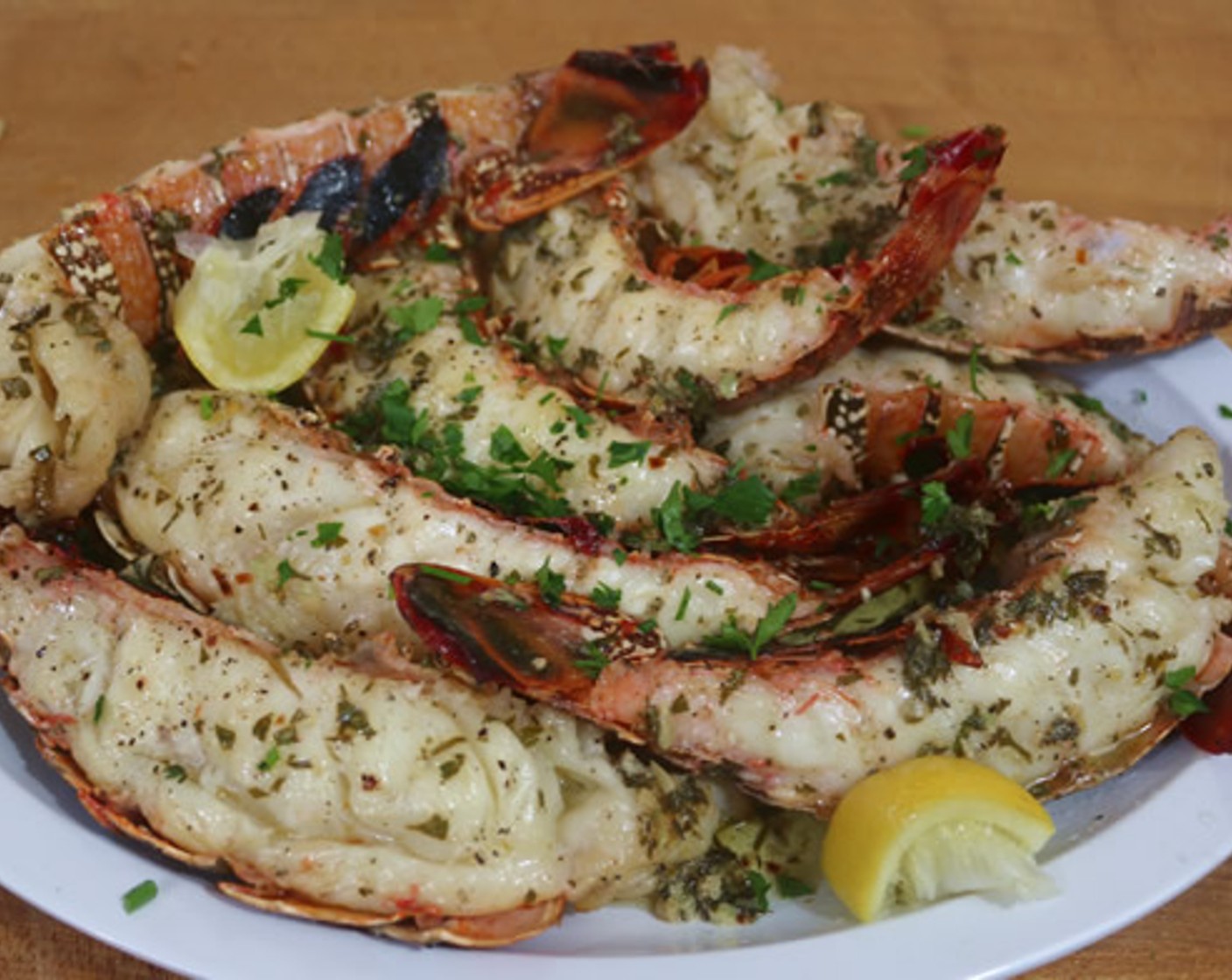 step 8 Serve with remaining butter mixture, fresh parsley, and lemon wedges.