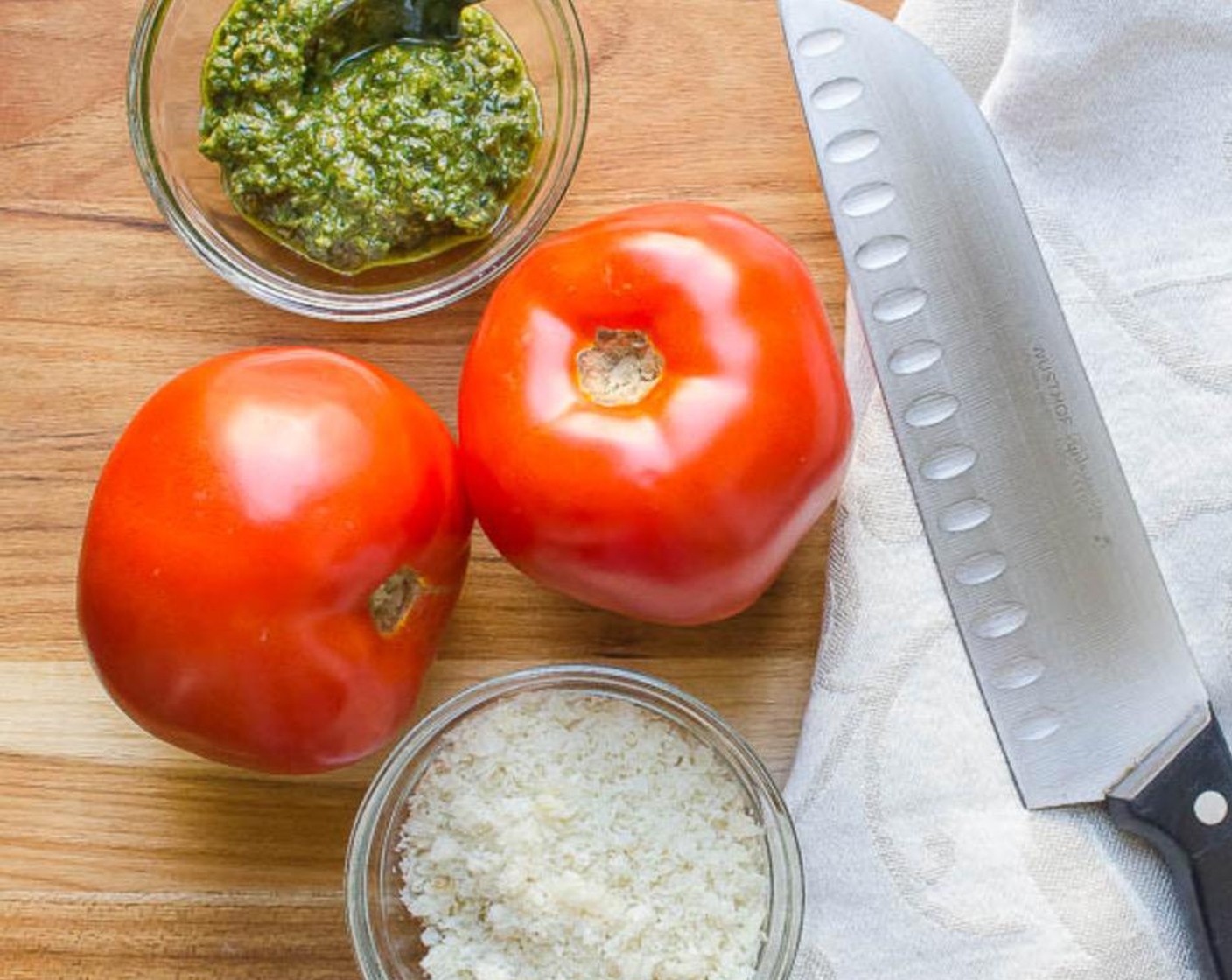 step 2 Carefully core the stem out of the Tomatoes (2) and discard. Slice the tomatoes in half, crosswise. Remove the seeds from the tomatoes. Drizzle each tomato with one teaspoon of Olive Oil (1 1/3 Tbsp).