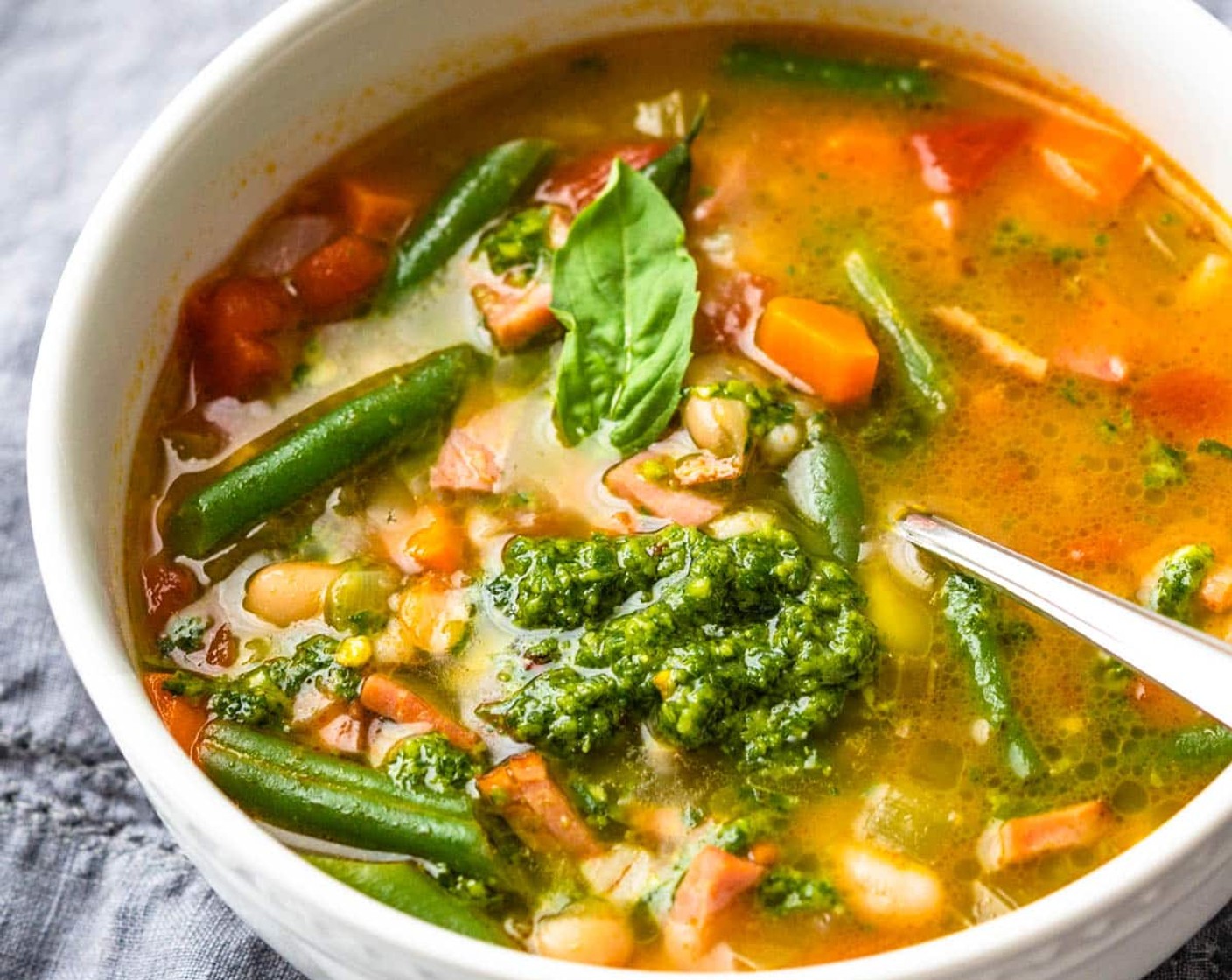 step 9 Ladle the soup into individual serving bowls and add a tablespoon of pistou to the hot soup. Swirl it into the soup and enjoy.