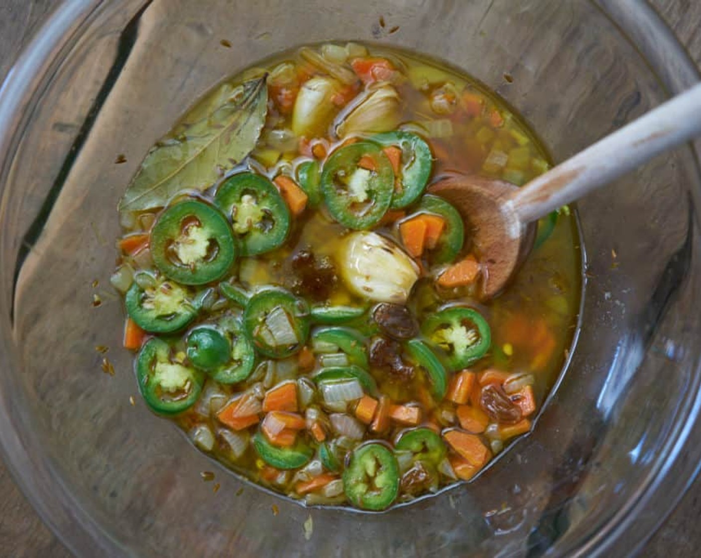 step 7 Remove bay leaf and pour the mixture into the bowl with the jalapeños and raisins. Stir to combine.