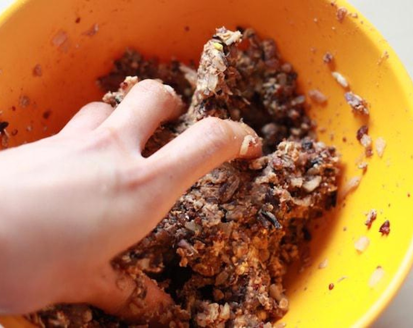 step 6 Use your hands in the mixture. If your veggie meat is too wet and doesn't stick together, add Oats (1/2 cup) little by little to fix the situation.