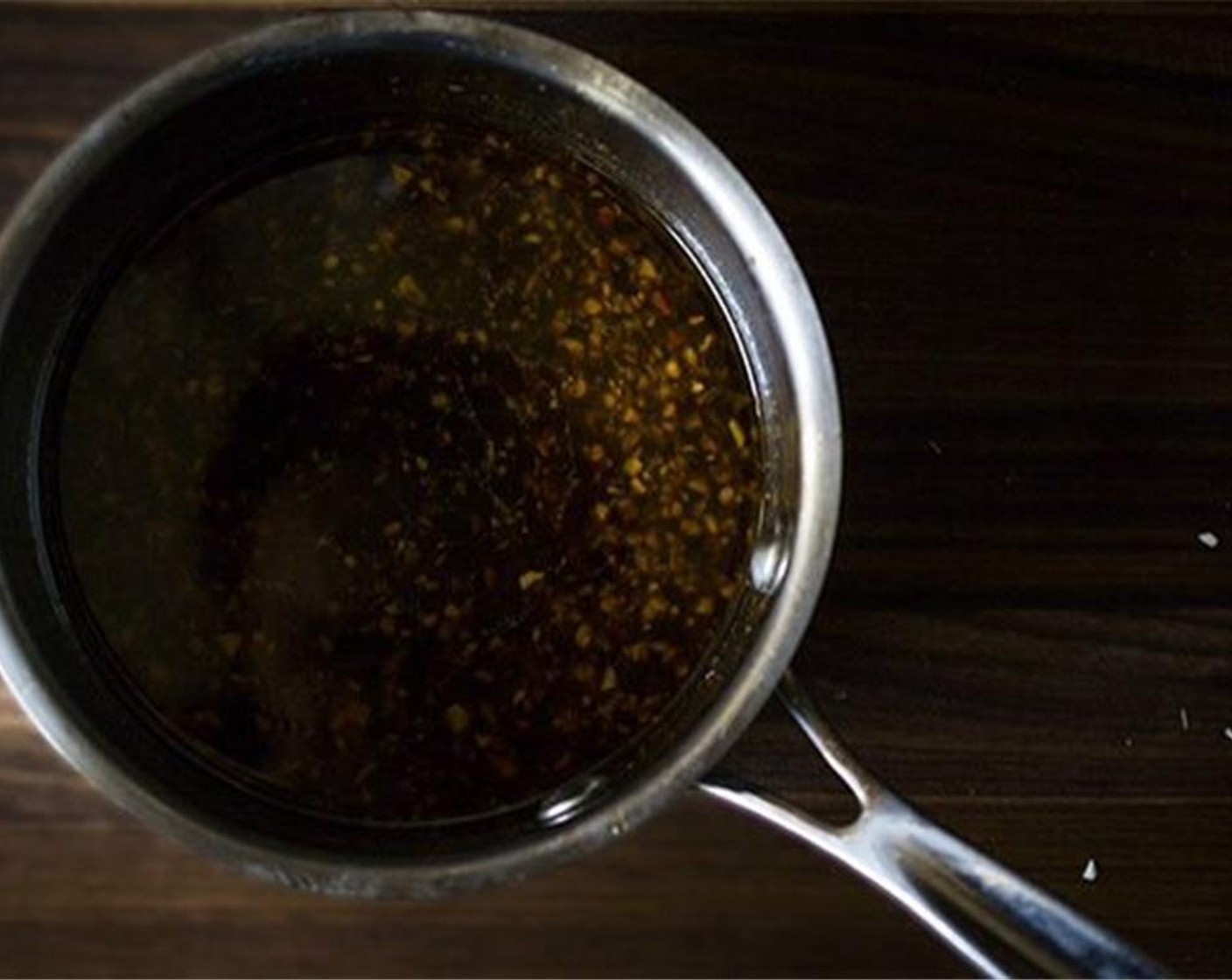 step 10 Remove the pan from heat and add Crushed Red Pepper Flakes (1 tsp). Let cool for 5 to 10 minutes. Once cool, add minced  Garlic (1 1/2 cloves), Worcestershire Sauce (3 Tbsp), and Fresh Ginger (1 Tbsp).