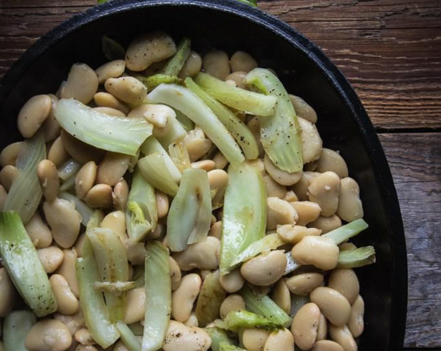 step 4 Pour the fennel and beans onto a large baking sheet. Rub the skin of each fish with Olive Oil and then season each fish inside and out with Sea Salt Flakes (to taste) and Freshly Ground Black Pepper (to taste).