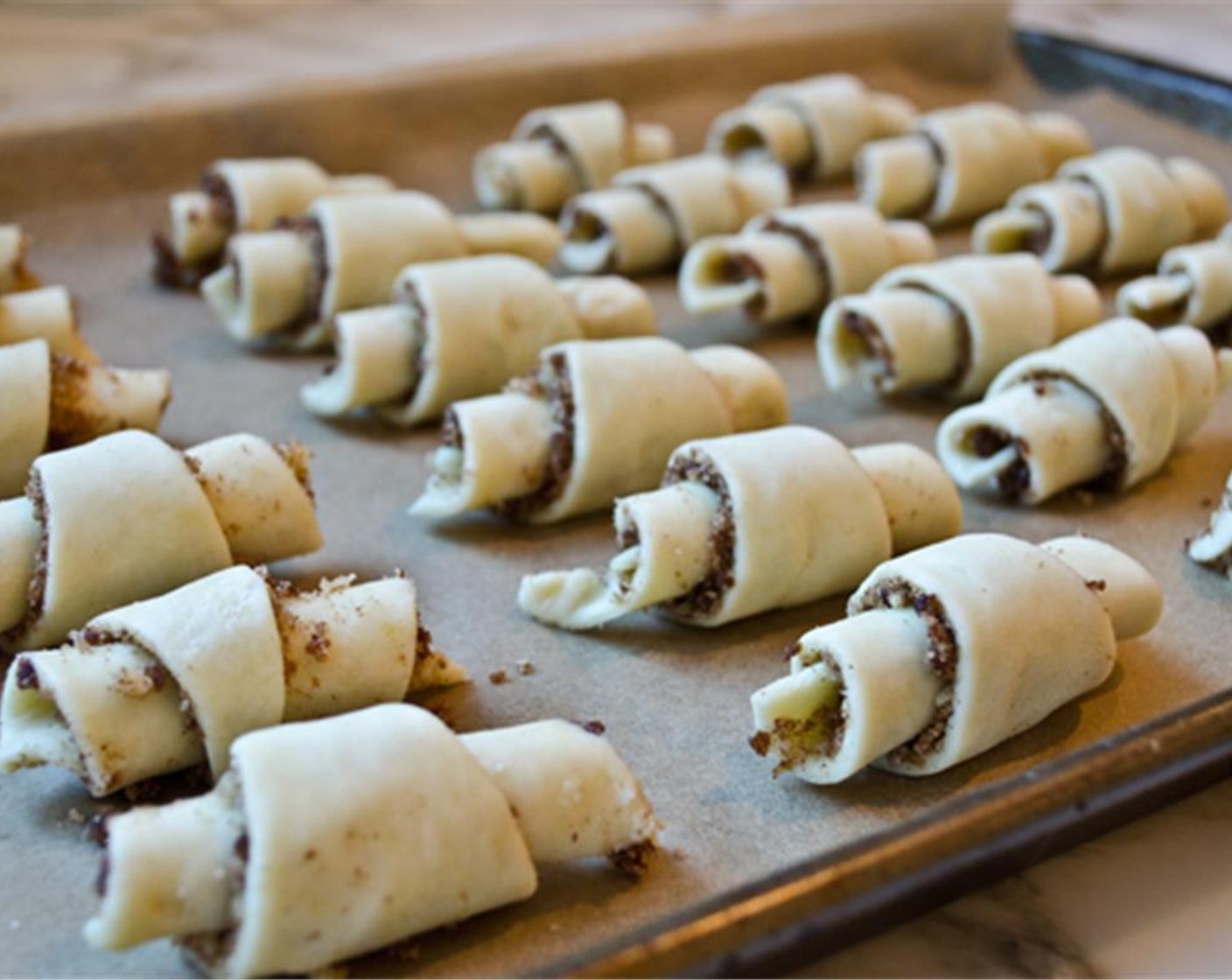 step 10 Place the rolls point-side down, about an inch apart, on the prepared baking sheets. Repeat with the remaining dough.