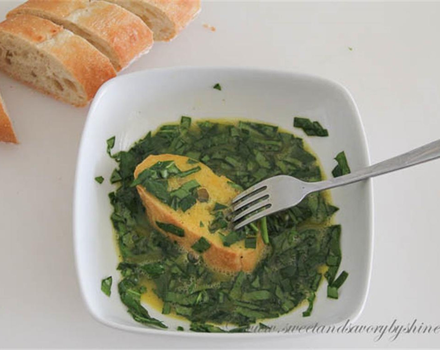 step 4 Mix chopped spinach  into the eggs. Soak the slices of baguette in the egg and pierce with a fork here and there. This will help to really soak the bread with the egg mixture for a softer center. Spread the spinach evenly on the bread.