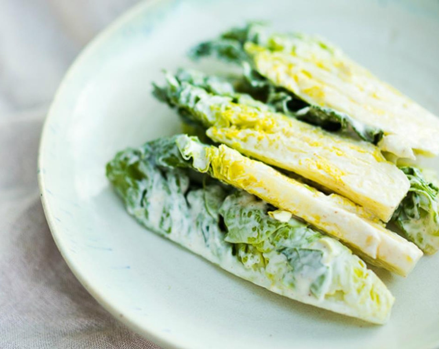 step 8 To assemble: Toss lettuce gently with a little dressing, just enough to coat. Lay the dressed lettuces on each plate, creating a bed for the salmon.