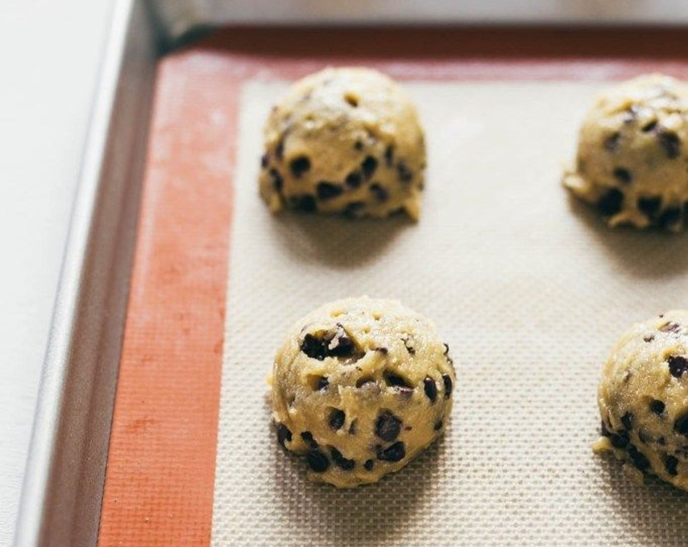 step 3 Scoop the cookie dough out with a cookie scoop and place on a lined baking sheet two inches apart from one another.