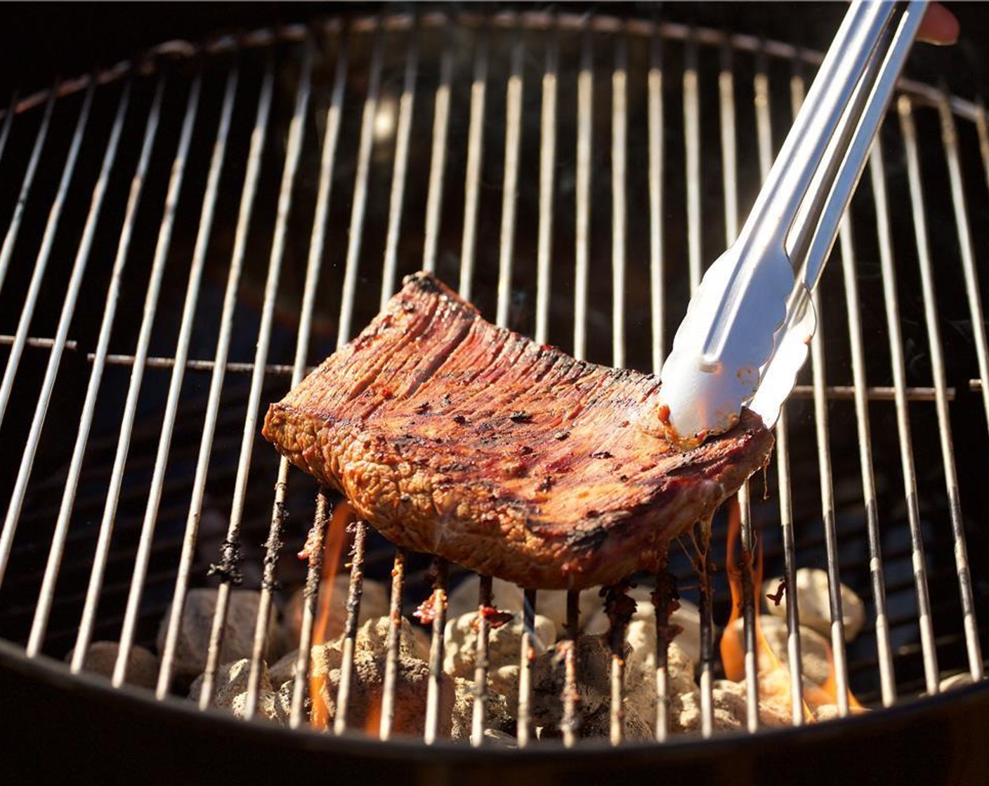 step 14 Place the flank steak on the hottest side of the grill and cook for 2 minutes. After 2 minutes give the steak a quarter turn on the grill to create cross hatch grill mark.