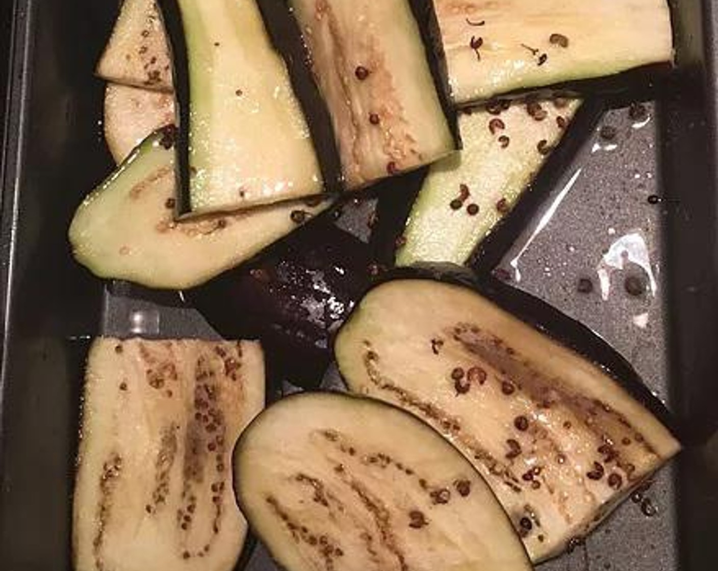step 2 Thoroughly rinse the eggplant, and return to the baking dish, adding a thin layer of Oil (as needed) and the Sichuan Peppercorns (4 Tbsp) . Set that aside.