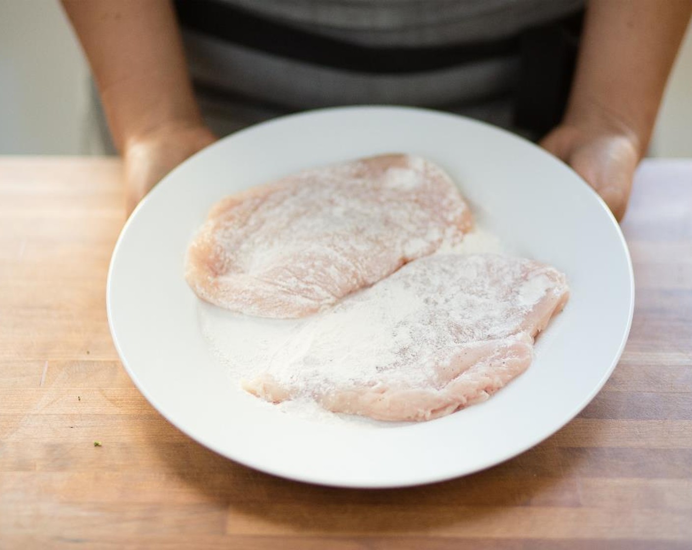 step 9 Place chicken in the seasoned flour and turn to coat thoroughly. Tap off any excess seasoning.