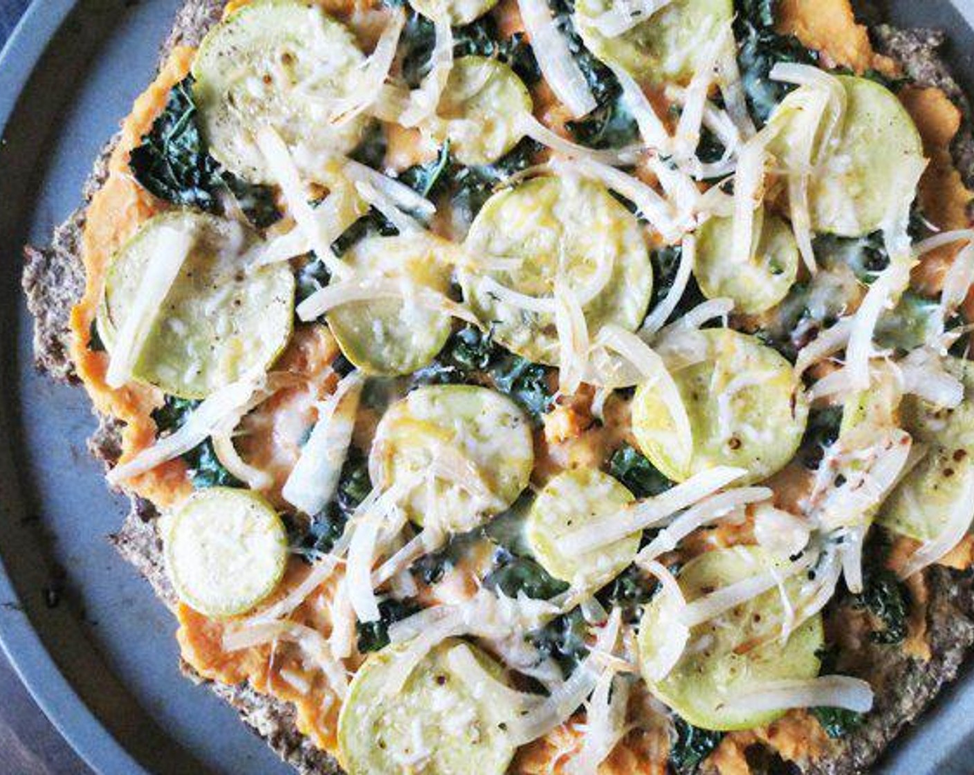 step 8 Add Kale (1 handful), Onion (1/2), Shredded Cheese (1/4 cup), and Yellow Squash (1) to pan and saute until tender-crispy.