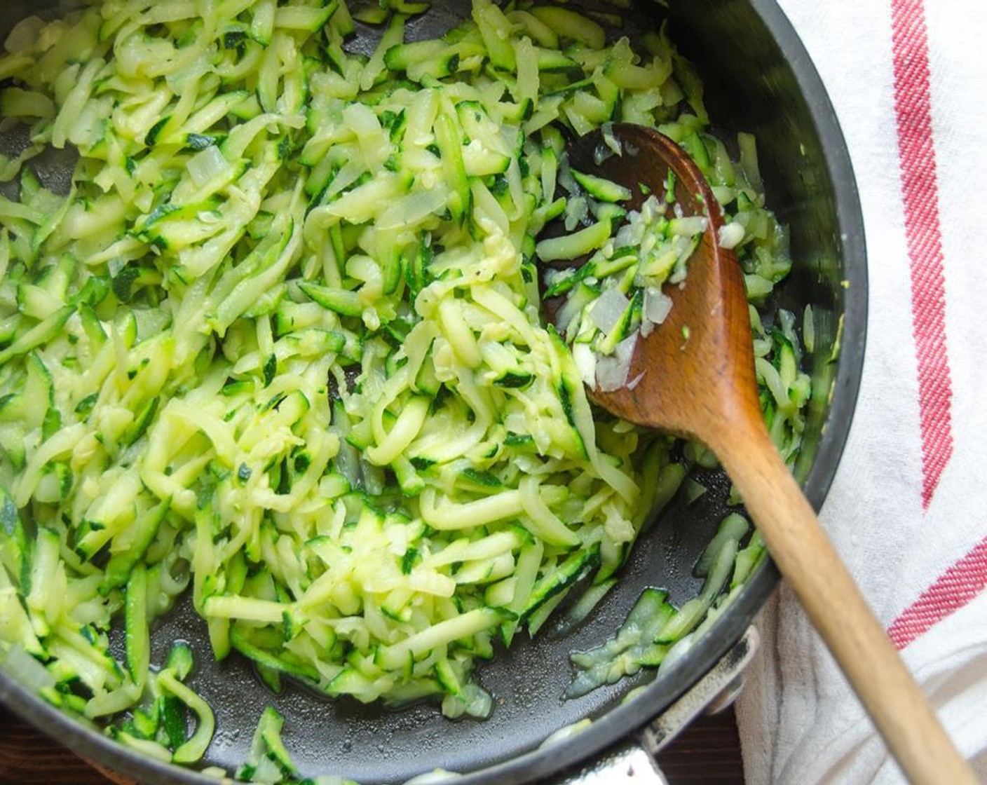 step 5 Add remaining Olive Oil (1 Tbsp) to the skillet and add the grated zucchini. Sprinkle with a pinch of salt and cook until zucchini is wilted and softened - about 5 minutes.