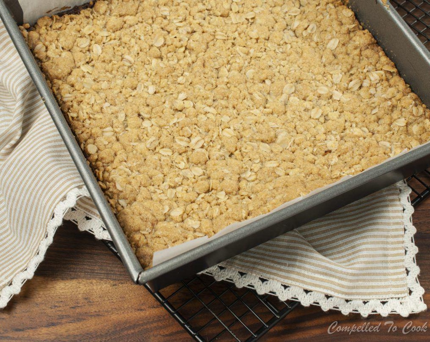 step 5 Evenly press a generous half of the oat mixture, about 3 cups, into the bottom of prepared pan. Spread dates evenly over oats. Add remaining oat mixture, pressing slightly.