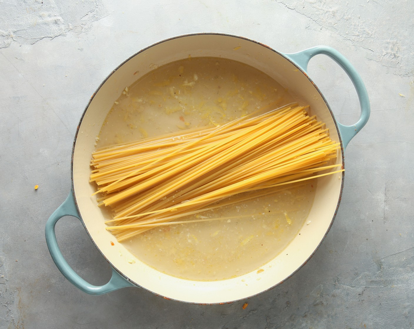 step 2 To the same skillet, add the Water (5 cups), White Wine (1/2 cup), Lemon (1), Salt (1/2 tsp), and Spaghetti (1 box). Simmer uncovered for 9-10 minutes, until the spaghetti is cooked to your liking.