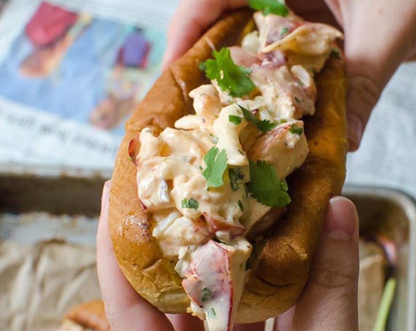 step 7 Pile the buns with lobster salad and garnish with additional cilantro and Sriracha.