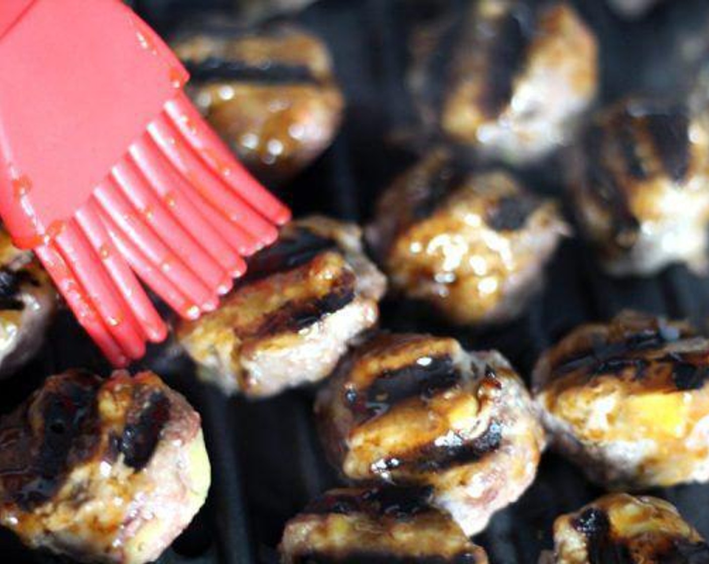 step 3 Oil grill grate. Heat grill to 425 to 450 degrees F (220 to 230 degrees C). Grill the meatballs for 12 to 15 minutes, turning frequently to brown all sides well.