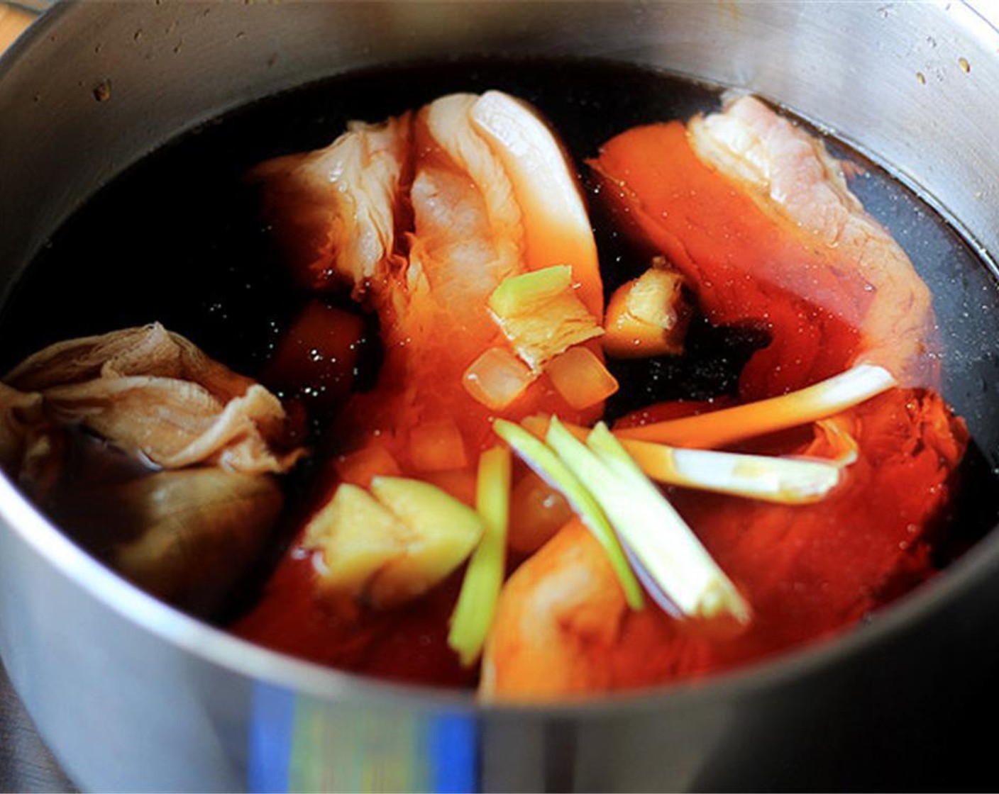 step 3 In a pot, add pork belly, the spice bag, Fresh Ginger (1 in), Crystal Sugar (1 Tbsp), Scallion (1 bunch), Salt (1 tsp) and Dark Soy Sauce (3 Tbsp). Pour in enough Water (to taste) to cover the pork belly. Bring to boiling then turn now the flame and simmer for 2 hours.