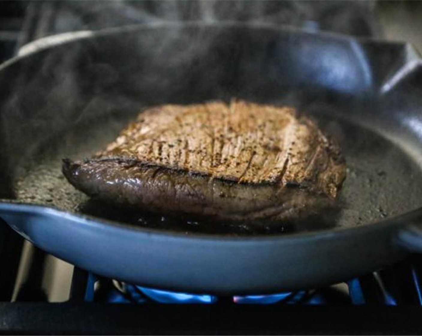 step 4 Preheat a grill to medium-high heat. Cook the steak about 5-6 minutes on the first side, flip, and cook for additional 3-4 minutes or until slightly pink in the middle. Remove from heat and set aside to rest before slicing into strips.