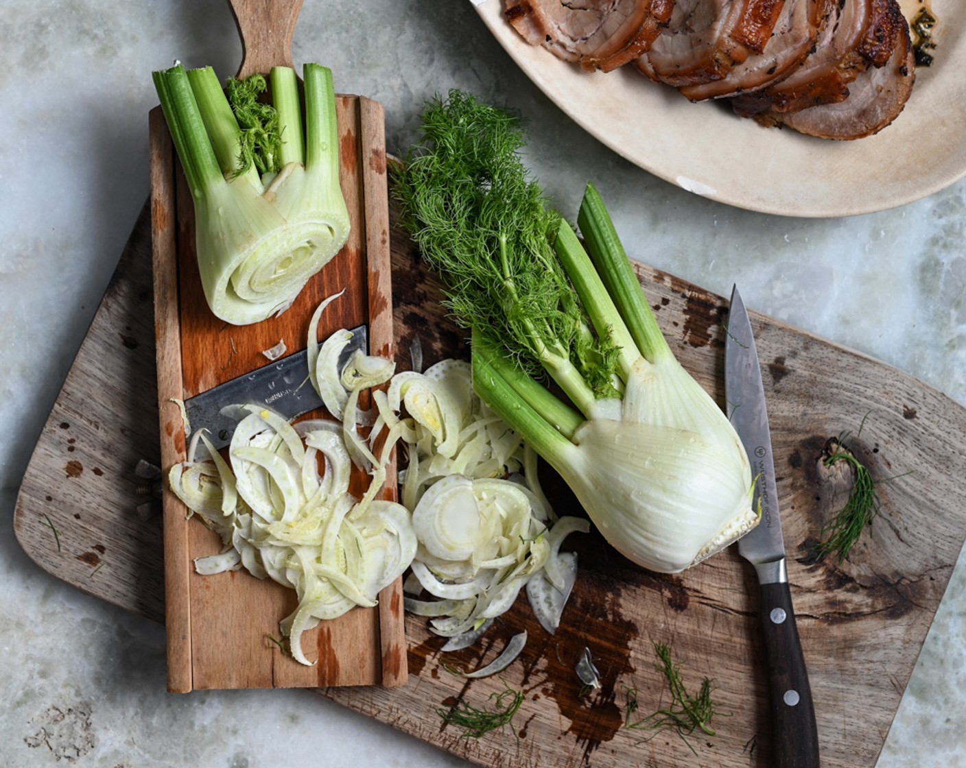 step 11 For the slaw, use a sharp knife to slice the Butter Lettuce (1 head) into ribbons and thinly cut the Fennel Bulb (1). Retain some of the fennel tops to use in the slaw. Combine the lettuce and fennel in a bowl and drizzle over some olive oil.