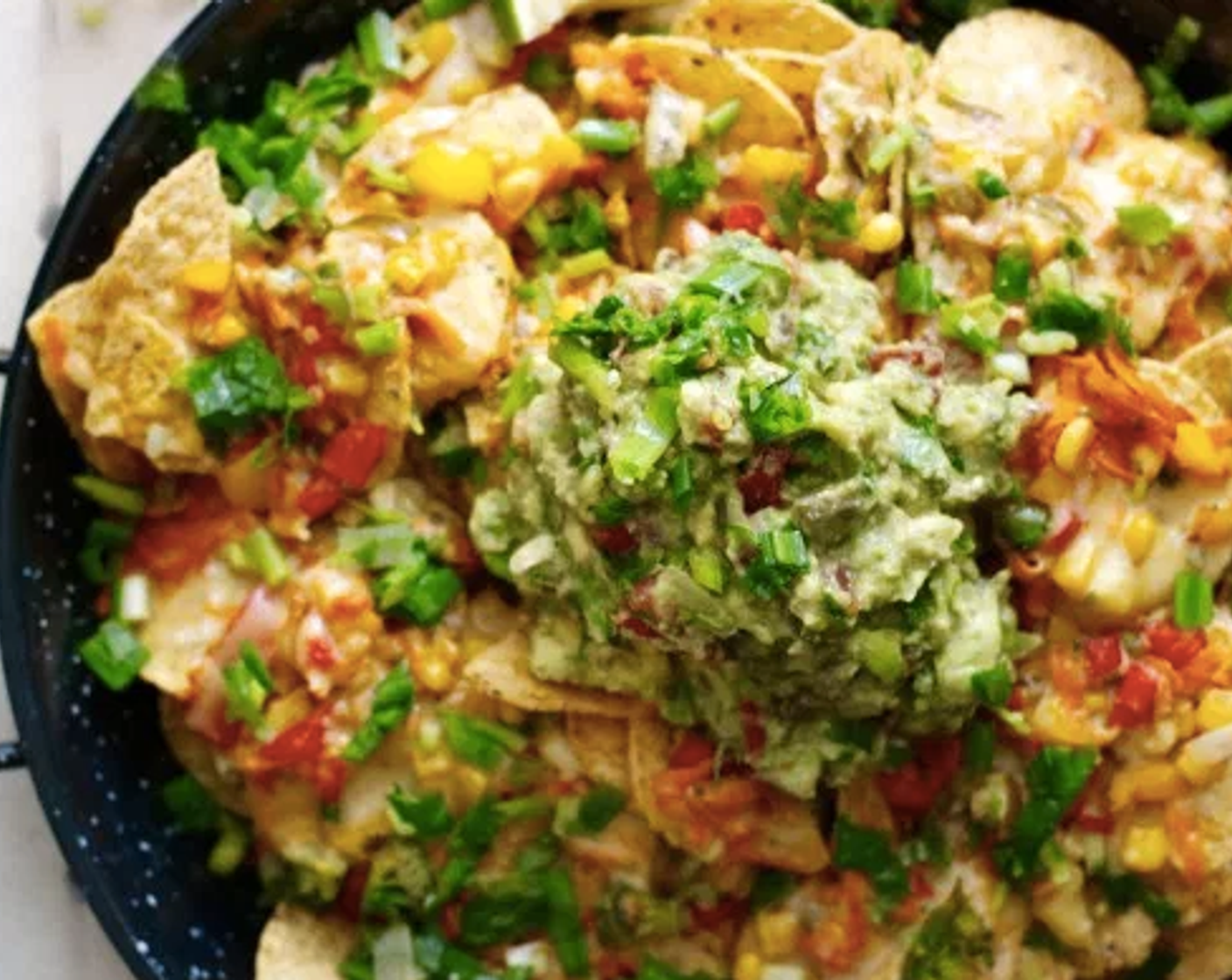 step 9 In a large pan spread out your Tortilla Chips (14 cups). Add your veggie mix to your cheese mix and stir well. Put in oven for about 10 minutes. Put on your desired platter and squeeze the Lime (1/2) or pour the lime juice over the nachos.