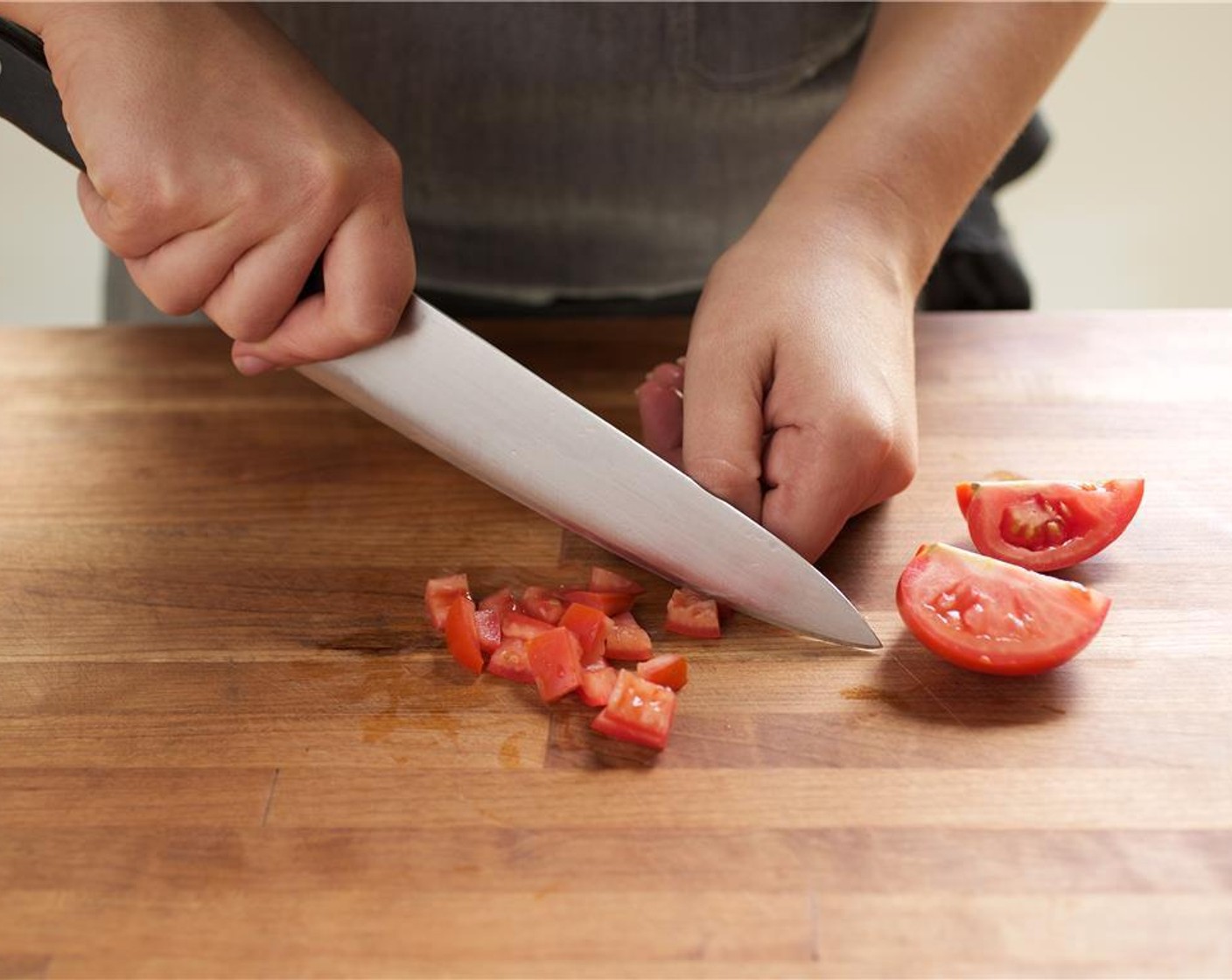 step 2 Cut the Roma Tomato (1) lengthwise into four wedges. Scoop out the seeds and discard. Slice the tomato into thin, long, quarter inch strips, and then cut across the strips into half inch diced pieces.