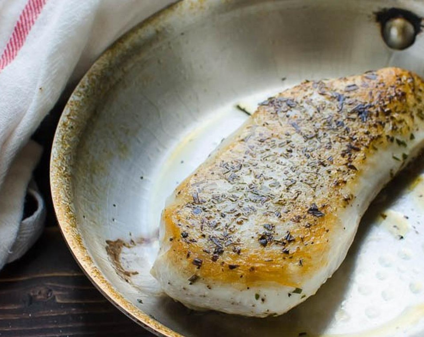 step 3 Heat Olive Oil (1/2 Tbsp) in a small ovenproof skillet over medium high heat. When pan is very hot, add the chicken and sear for 1-2 minutes on each side, until it starts to brown.