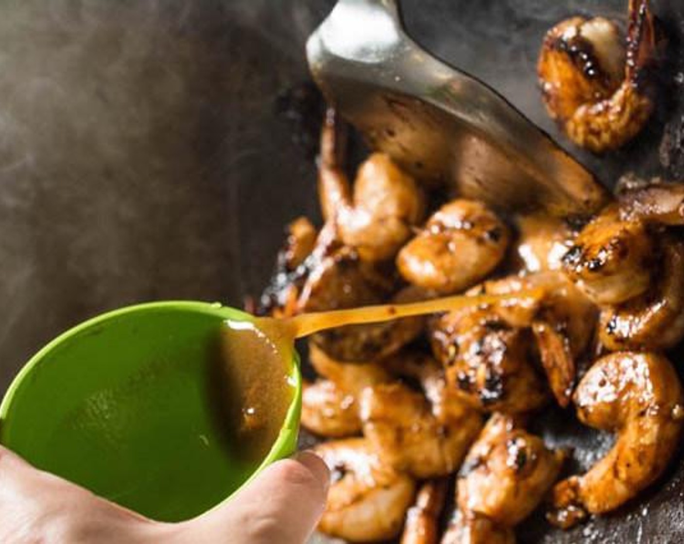 step 4 Just before the shrimp are fully cooked, pour the marinade liquid into the wok. If you prefer your Tamarind Shrimp with more sauce, simply add more water.