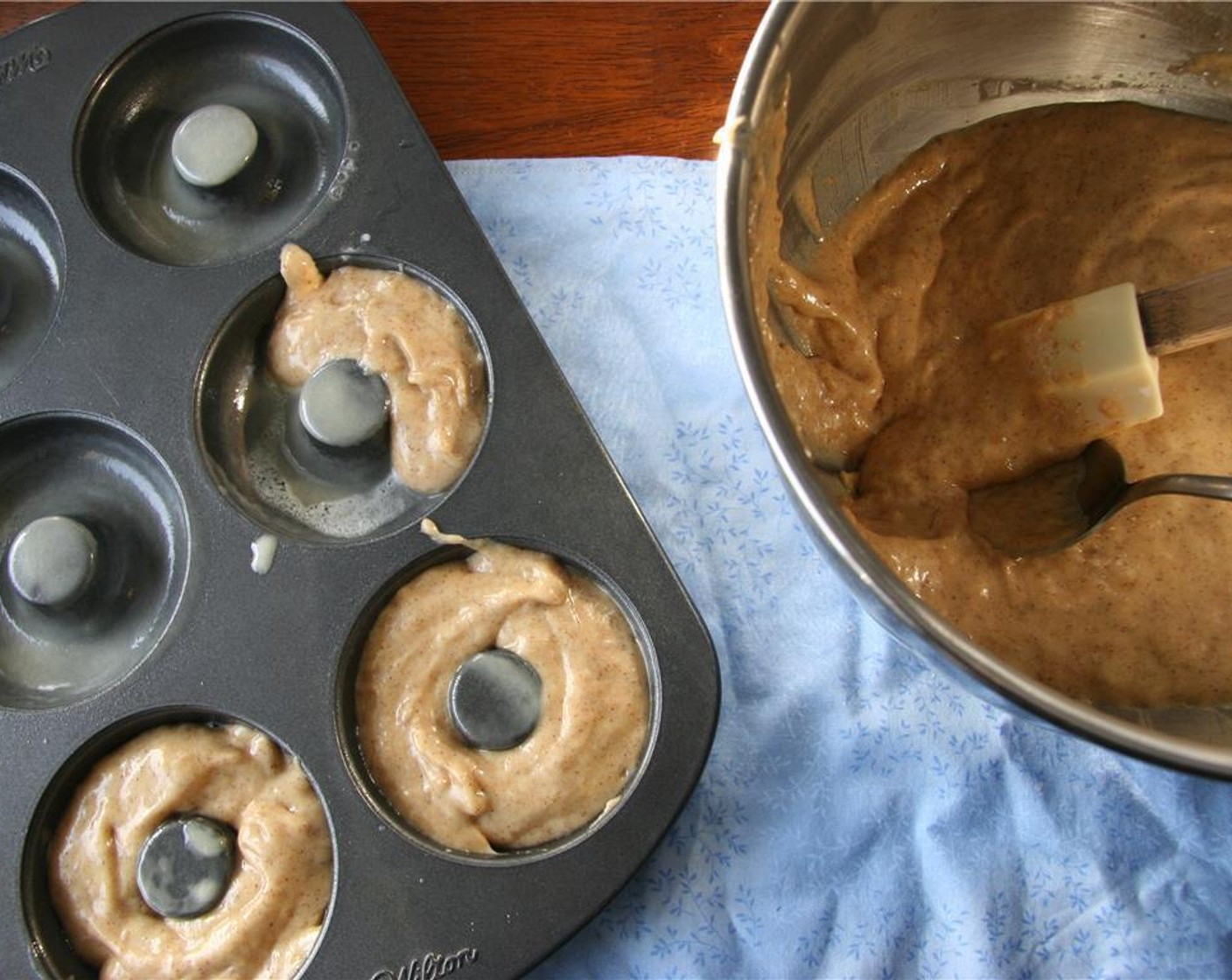 step 4 Spoon batter into greased doughnut pan about 3/4 full. Bake for 12 minutes. Place on wire rack to cool completely.