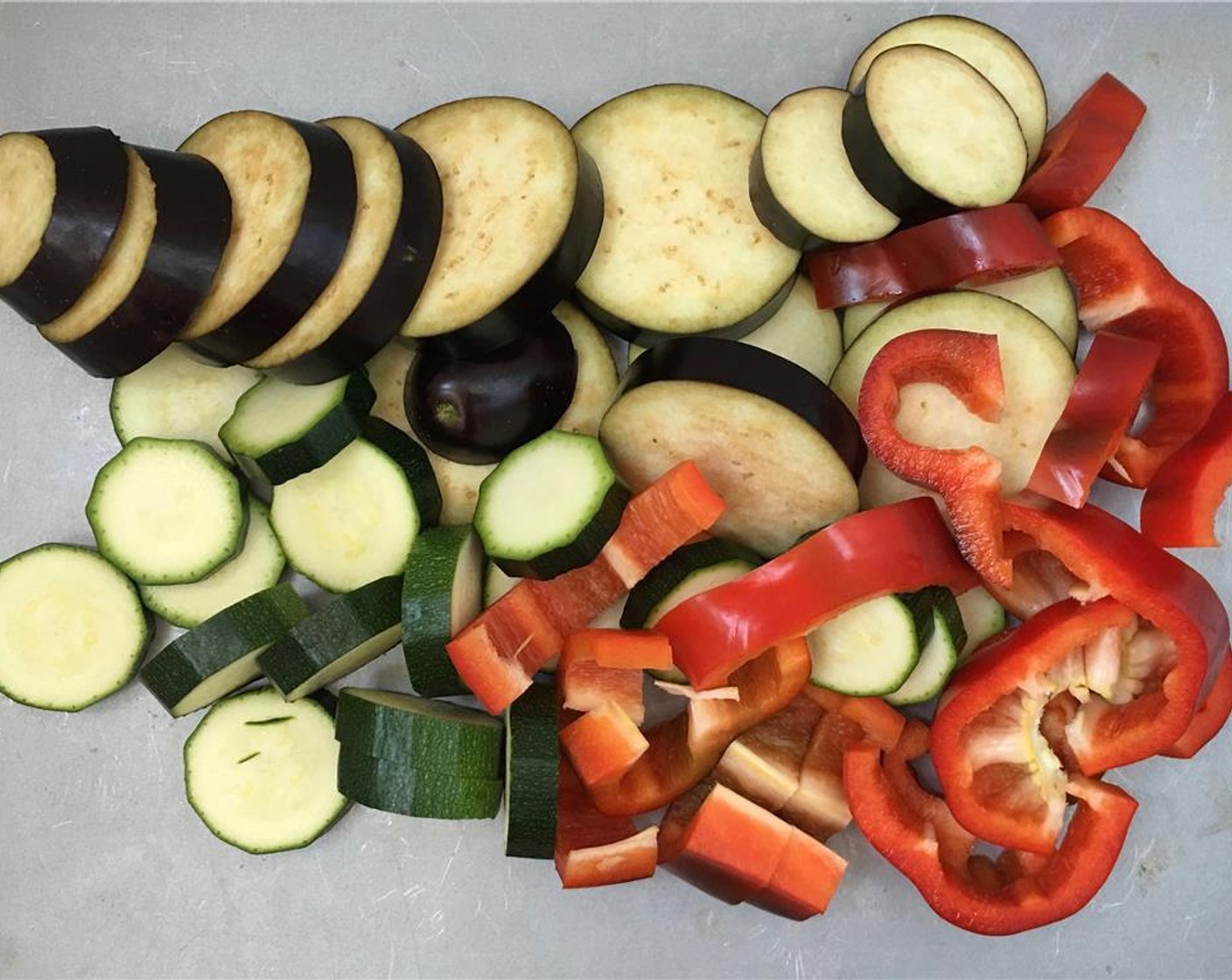 step 2 Rinse the Eggplant (1), Zucchini (1), Red Bell Pepper (1) and slice them into 1/2 inch (1 cm) thick bits.