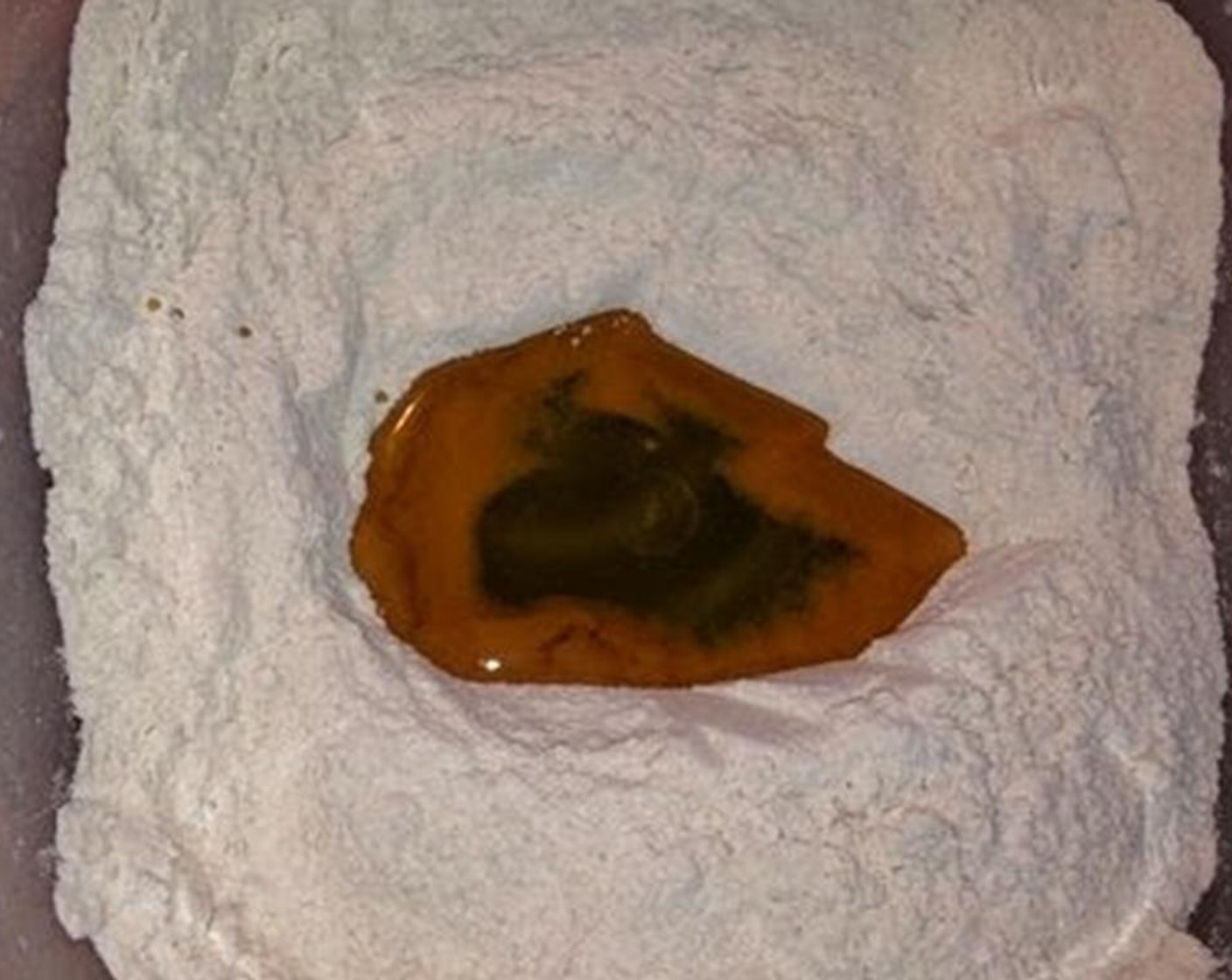 step 2 Make a well in the middle and add the Oil (4 Tbsp).