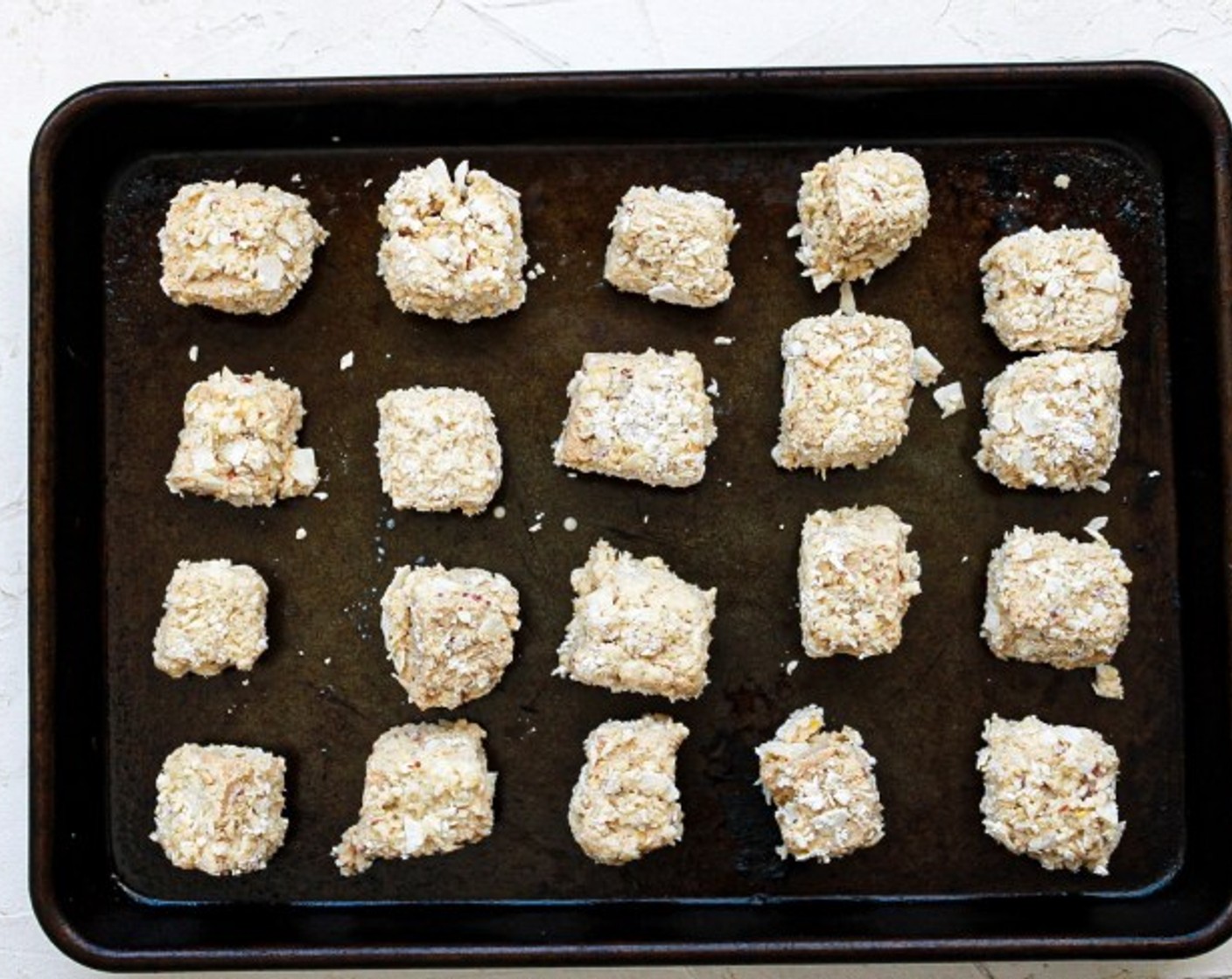 step 10 Remove the tofu from the container or bowl and place it on a separate sheet or paper towel. Repeat until all tofu pieces are coated.
