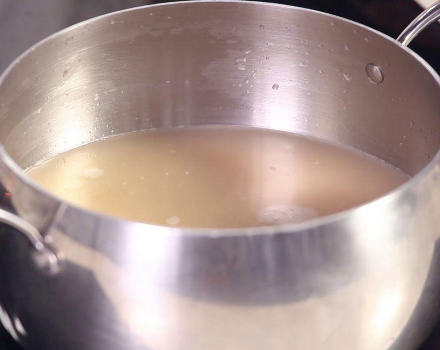 step 2 Put the ground shrimp into the pan. Crack an Egg (1) and add Water (6 1/4 cups), beat the mixture well, then turn on the hob.