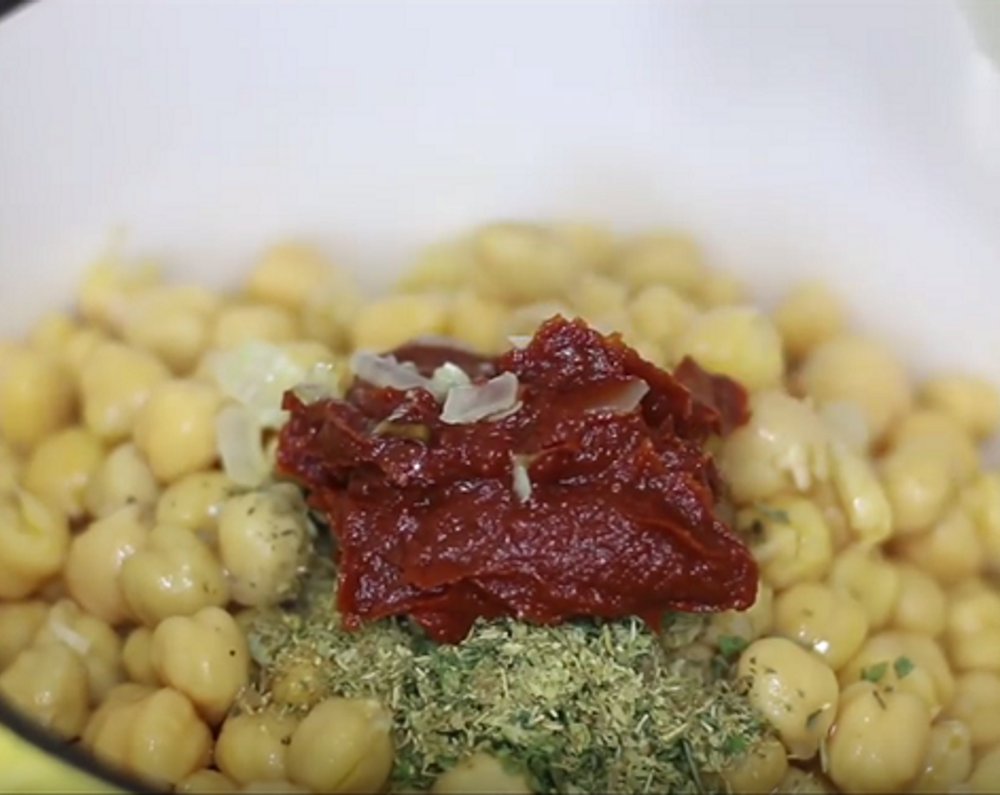 step 2 Mix in Garlic (2 cloves), saute for 30 seconds, then add Green Bell Pepper (1/4 cup), Tomatoes (2), Carrot (1/2 cup), Chickpeas (2 cans), Dried Basil (1/2 tsp),  Dried Parsley (1 tsp), Dried Oregano (1/2 tsp), and Tomato Paste (2 Tbsp).