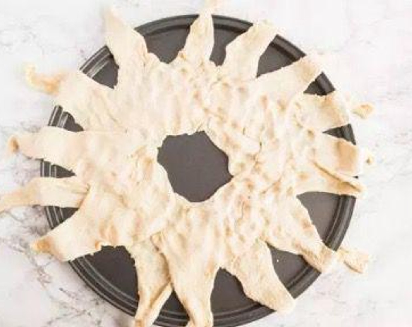 step 5 Arrange the Crescent Roll Dough (2 cans) on large round pizza pan or baking sheet in a "sunburst" style.