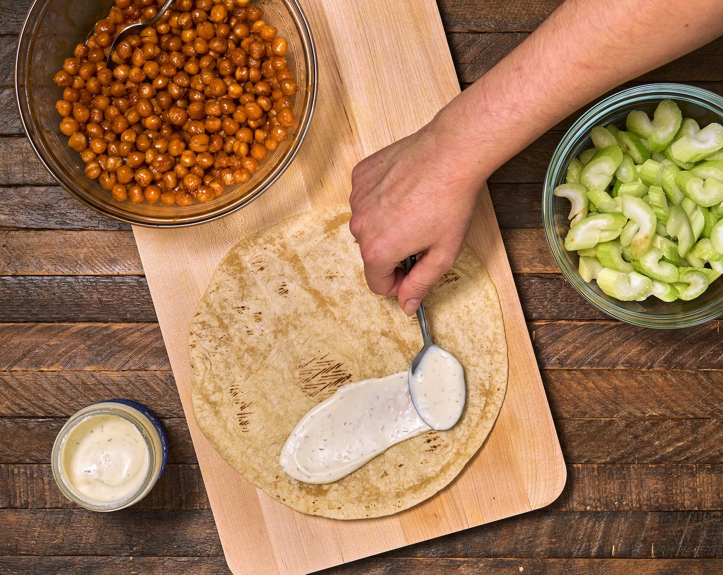 step 5 Build the wraps. First, spread a spoonful of Blue Cheese Dressing (1/2 cup) onto each Large Flour Tortillas (4).
