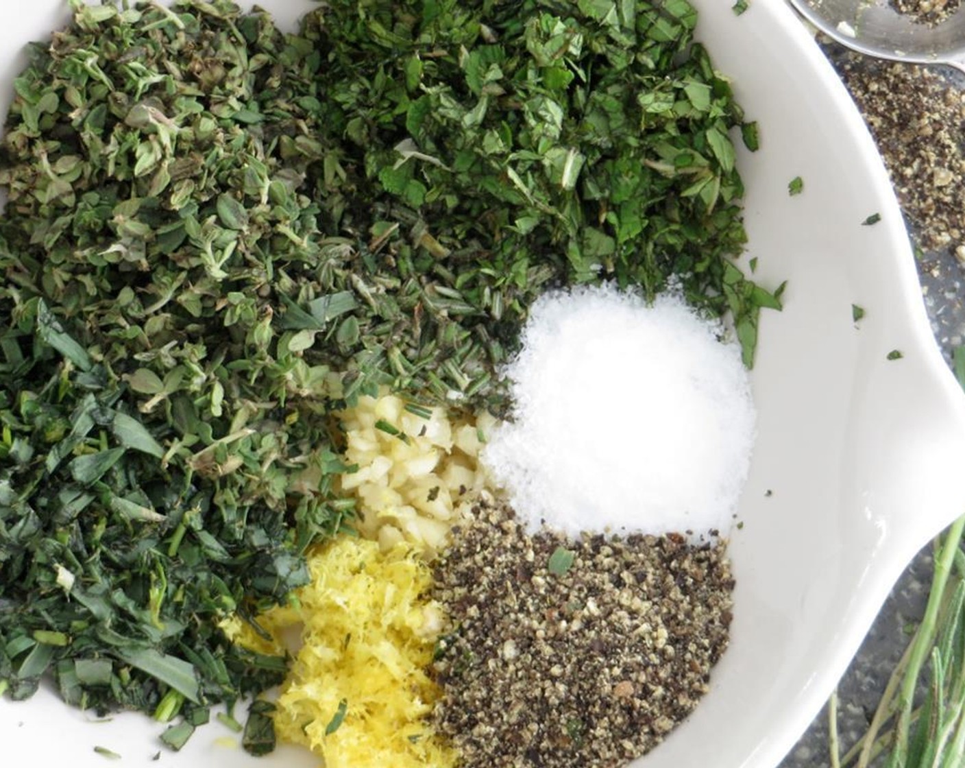 step 1 For the marinade, combine Garlic (4 cloves), Lemon (1), Fresh Rosemary (1 1/2 Tbsp), Tarragon (1 Tbsp), Fresh Thyme Leaves (2 Tbsp), Fresh Mint Leaves (1 Tbsp), Kosher Salt (1/2 tsp) and Ground Black Pepper (1/2 tsp) in a bowl and toss together with your fingers.