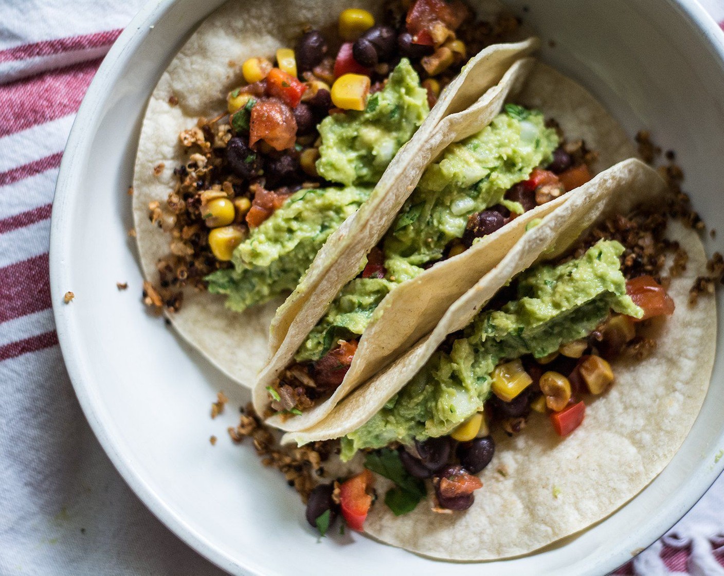 step 10 FOR TACOS: Add a layer of cauliflower quinoa taco meat to each baked tortilla shell, followed by a spoonful of guacamole and black bean corn salsa. Add other desired toppings and serve!