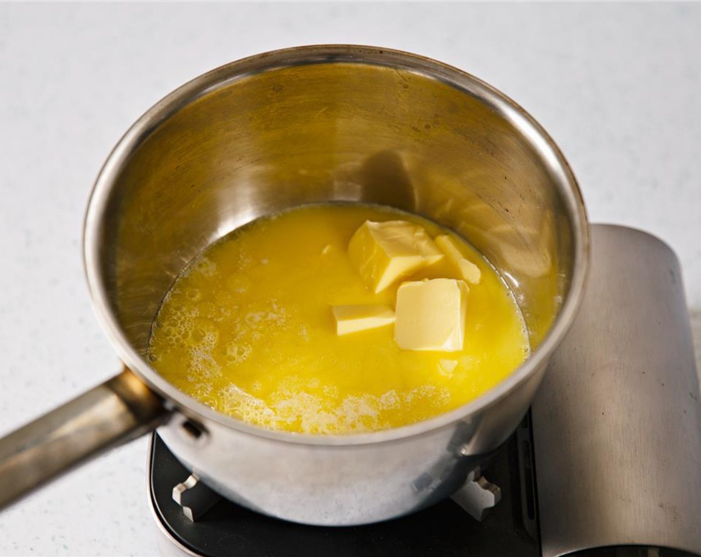 step 3 Place Unsalted Butter (1/2 cup) in saucepan, and heat until melted.