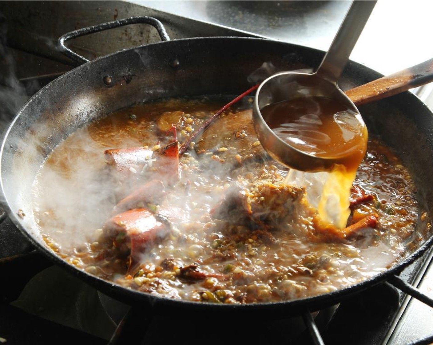 step 18 Start adding hot lobster stock until covered. Season with Salt (to taste) and Ground Black Pepper (to taste). Cook over high heat for the first 5 minutes to seal the grain and prevent the rice from breaking down later on.