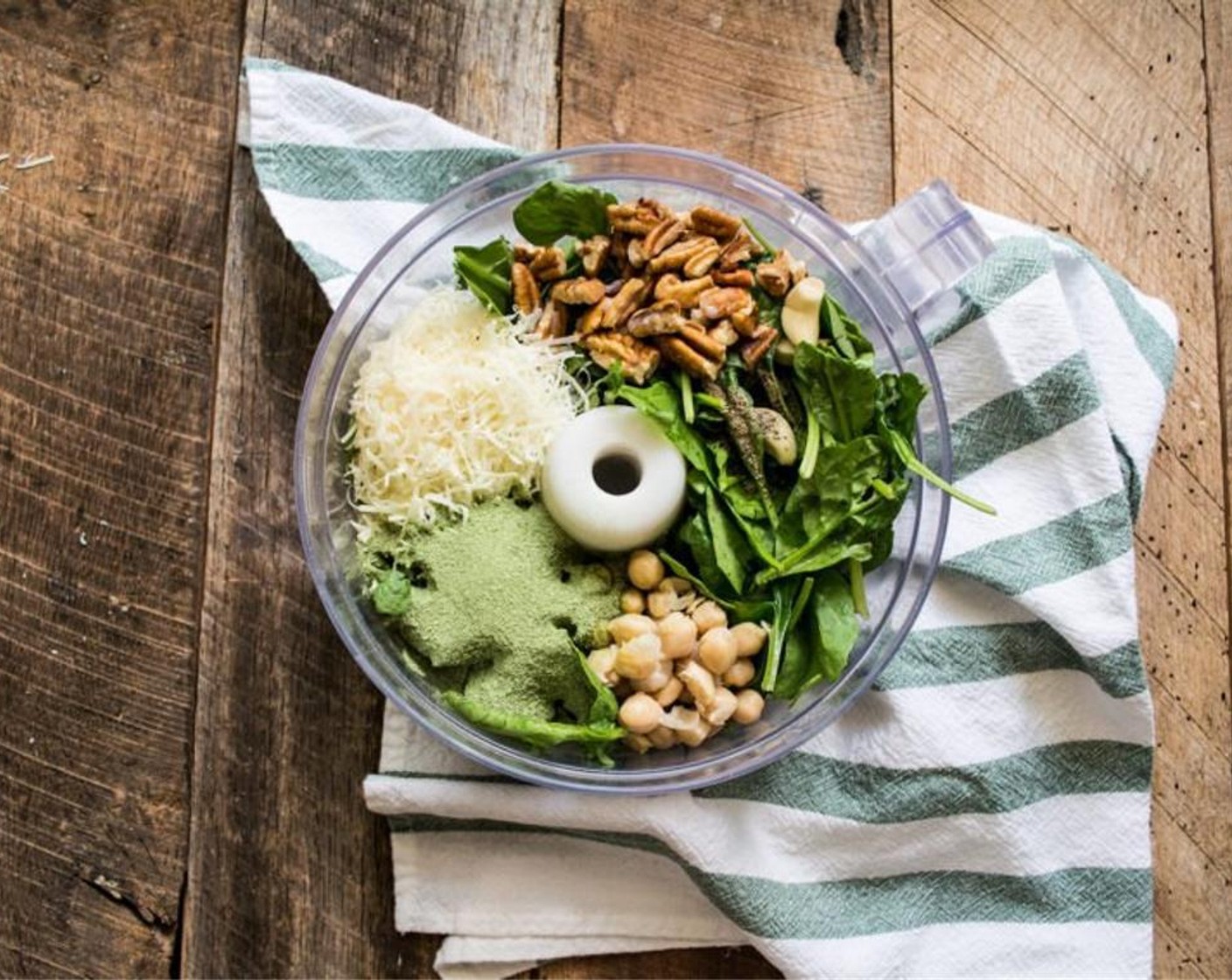 step 3 Add Fresh Spinach (2 cups), Pecans (1/4 cup), Collagen Beauty Greens (1 scoop), Parmesan Cheese (1/2 cup), Garlic (1 clove), juice from Lemon (1), Salt (1/2 tsp), Ground Black Pepper (1/4 tsp), Coconut Oil (1 Tbsp) and  Canned Chickpeas (1/4 cup) to the bowl of a food processor.