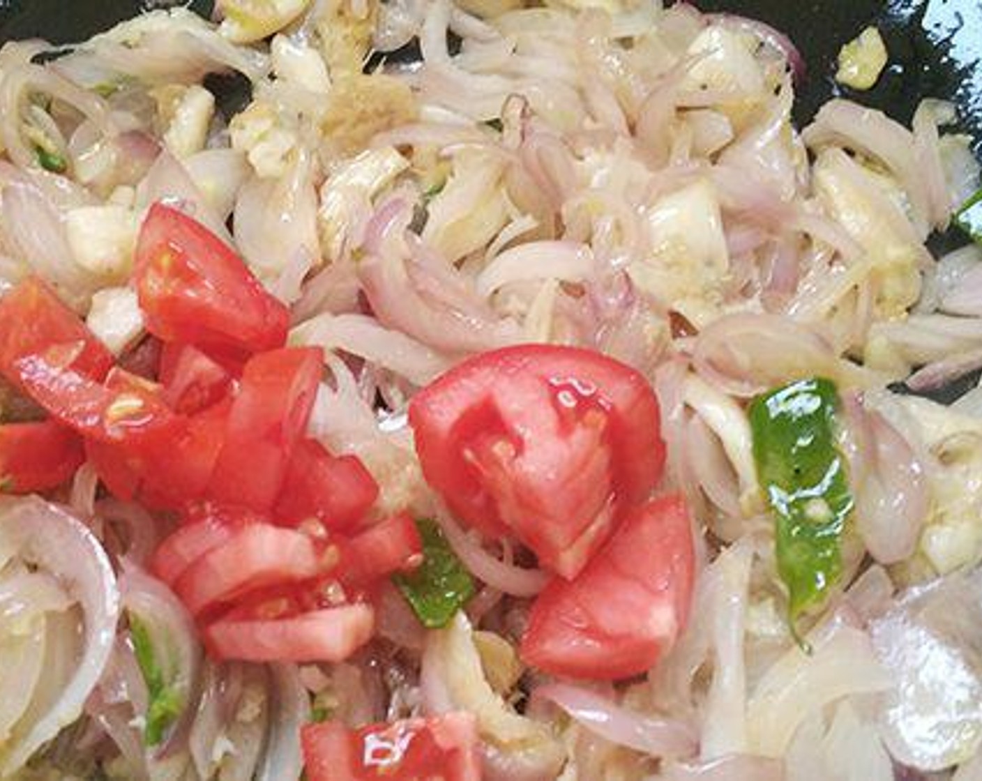 step 2 To a pan add Oil (3 Tbsp), Onions (3) and sautee till it becomes soft. Add Fresh Ginger (1 Tbsp), Garlic (1 Tbsp), and Green Chili Peppers (4). Sautee till the raw smell goes away. Add Tomato (1) and cook well.