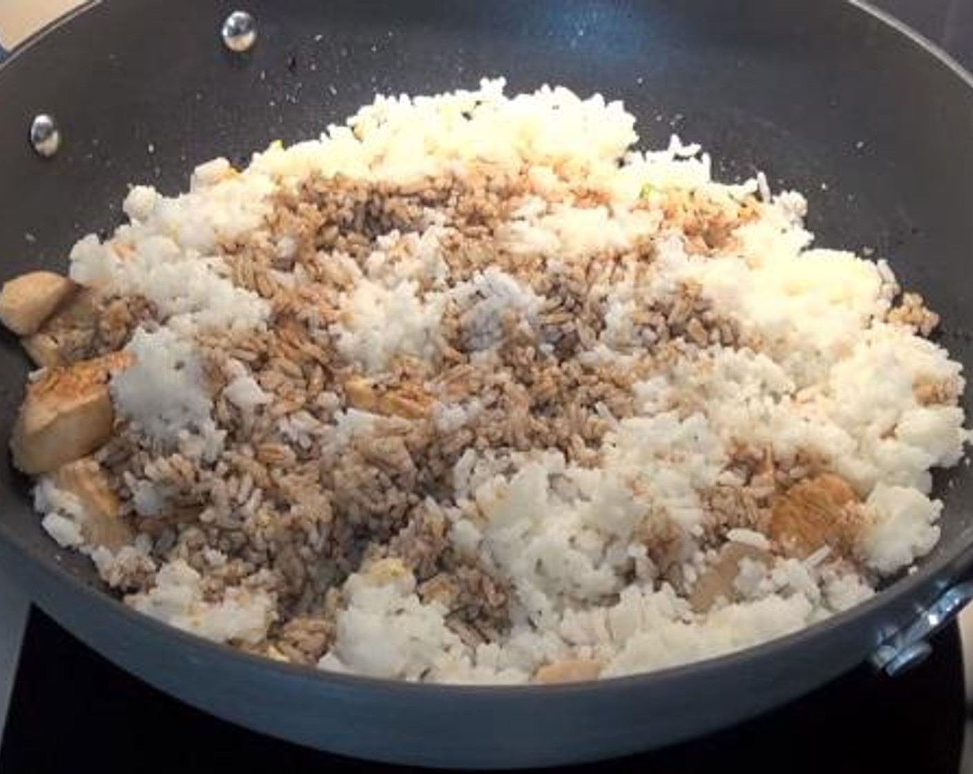 step 3 Add in the Eggs (2), and cook for a few minutes. Then, add in the chicken, and cooked White Rice (1 cup) into the wok. Sprinkle over with some Soy Sauce (1/4 cup), and mix everything together.