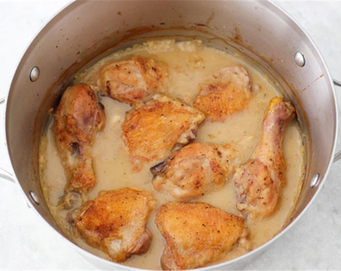 step 11 If your dutch oven/skillet is not oven proof, transfer the sauce and the chicken into a deep oven proof dish, otherwise you can keep it in the same pan that you started it in.