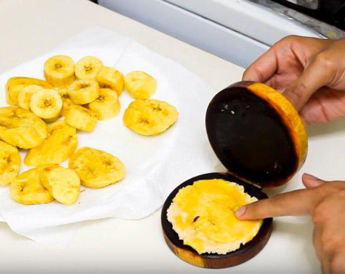step 4 Mash the plantain slices and return them to the oil. Cook for about 45 seconds on each side, or until crispy.