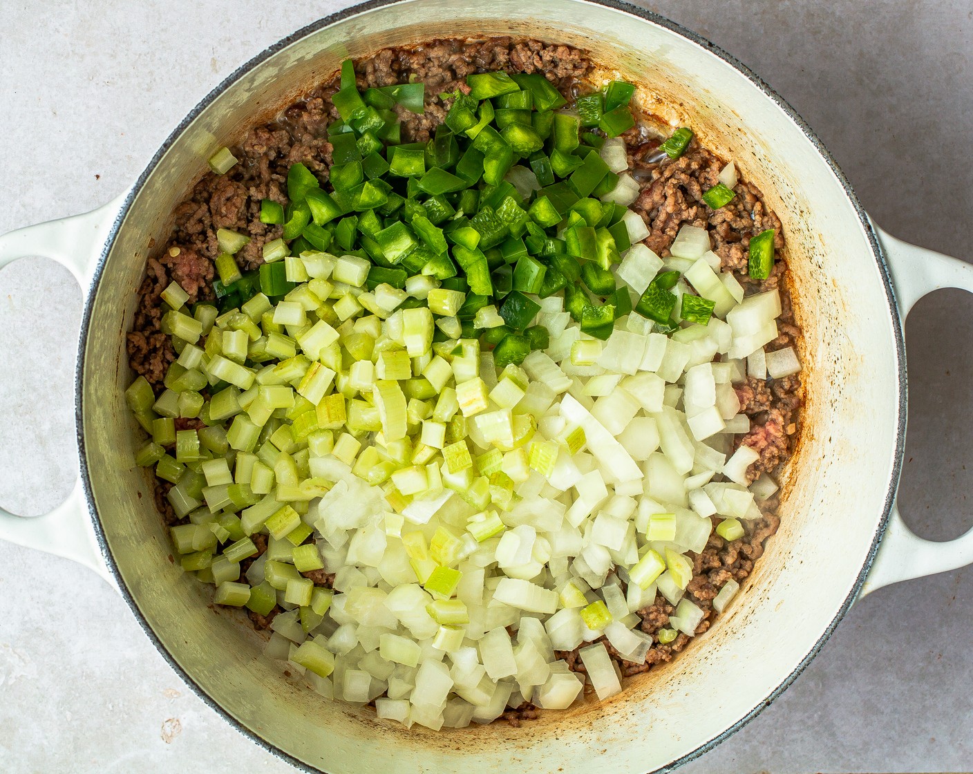 step 4 Add Yellow Onion (1), Green Bell Pepper (1), Celery (2 stalks), and cook for 3 minutes.