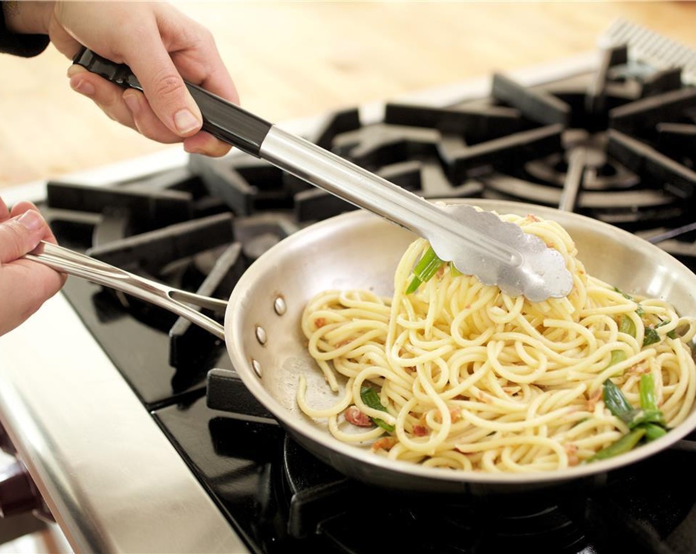 step 10 Add the cooked pasta and the reserved green onions to the pan with the sauce. Cook for two minutes.