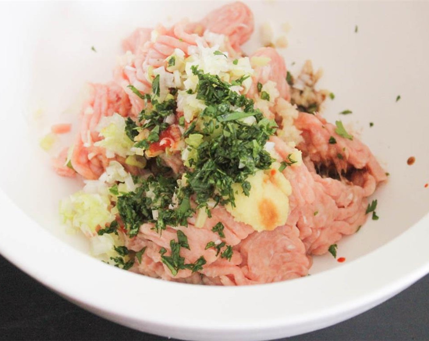 step 1 For the burgers, place Ground Chicken (1 lb), Low-Sodium Soy Sauce (1 Tbsp), Fresh Ginger (1 tsp), Sriracha (1 tsp), Garlic (2 cloves), Scallion (1 bunch) Fresh Cilantro (1 Tbsp) in a large bowl.