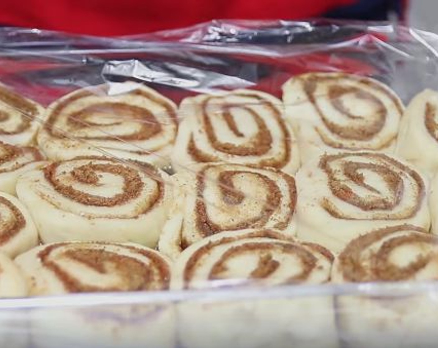 step 7 Once the dough has doubled in size, place on a floured surface and roll it out to a 16 inch rectangle. Spread the Butter (1/3 cup) and sprinkle evenly with the cinnamon sugar. Tightly roll the dough. Cut into 16 pieces. Place them cut side down on the pan. Cover with plastic wrap and allow to rise for 30-45 minutes.
